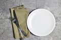 Festive fashion table setting. empty white plate with knife and fork, napkin.