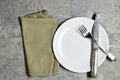 Festive fashion table setting. empty white plate with knife and fork, napkin.