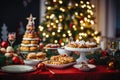 The festive feast set on the table amidst the backdrop of the beautifully adorned Christmas tree Royalty Free Stock Photo