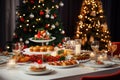 The festive feast set on the table amidst the backdrop of the beautifully adorned Christmas tree Royalty Free Stock Photo