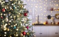 Festive fir tree branches with shiny red and golden baubles, balls, xmas ornaments and bright warm lights, garland. kitchen Royalty Free Stock Photo