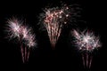 Festive fireworks colorful display isolated in bursting shapes on black background. Beautiful light for celebration. Show explosio Royalty Free Stock Photo