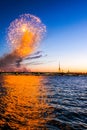 Festive fireworks on the waterfront at sunset