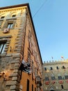 Festive flags of contradas on the old historical buildings before the traditional Palio race in Siena, Tuscany