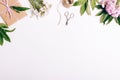 Festive flower arrangement, gifts and ribbons on a white table