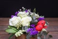 Festive flower arrangement of white roses, white and blue kermek and other plants, red eggs for Easter decorated on Royalty Free Stock Photo