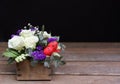 Festive flower arrangement of white roses, white and blue kermek and other plants, red eggs for Easter decorated on Royalty Free Stock Photo