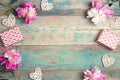 Festive frame of  pink peonies, gifts and hearts on an old turquoise background with shabby paint. Place for text Royalty Free Stock Photo