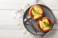 Festive fresh apple tartlets with custard decorated with mint close-up in a plate. Horizontal top view