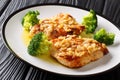 Festive fried chicken fillet with almonds served with broccoli close-up on a plate. horizontal Royalty Free Stock Photo