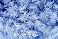 festive frosty pattern with white snowflakes on a blue background on glass Royalty Free Stock Photo