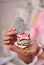 festive gingerbread in the form of a Christmas tree, stars in the hands of a girl. Royalty Free Stock Photo