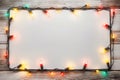 Festive Glow - Christmas Lights Bulb Frame on White Wood, Merry Christmas and New Year Holiday Background. created with Generative Royalty Free Stock Photo