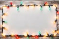 Festive Glow - Christmas Lights Bulb Frame on White Wood, Merry Christmas and New Year Holiday Background. created with Generative Royalty Free Stock Photo