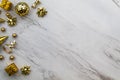 Festive gold decorations on white marble background copy space for New Year, Anniversary, Party, Birthday, Celebration, Sale Royalty Free Stock Photo