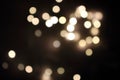 Festive golden blurred lights. Shiny bokeh. Abstract defocused lights. Glowing effect concept. Royalty Free Stock Photo