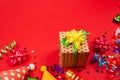 Festive golden and purple stars of confetti  and a present, birthday caps on a red background Royalty Free Stock Photo