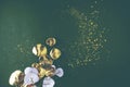 festive green background with sparkles and gold branch, leaves