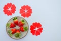 Festive grey background. Fresh ripe strawberries on a plate close up. Valentine`s Day. Food backgrounds. Creative greeting card