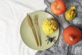 Festive Halloween autumn holiday dinner place setting. Seasonal table setting with pumpkins, spider, spiderweb and