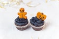 Festive Halloween cupcakes decorated with gingerbread cookies. Homemade sweets for the celebration of Halloween. Yellow Royalty Free Stock Photo