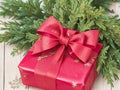 A festive hand-wrapped Christmas gift adorned with a bright red bow Royalty Free Stock Photo