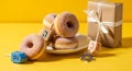 Hanukkah Celebration with Sweet Doughnuts and Gift Box Royalty Free Stock Photo