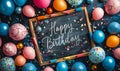 Festive Happy Birthday chalkboard sign with elegant script, surrounded by colorful party balloons, confetti, and drawing Royalty Free Stock Photo