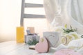 Festive heart shaped cookies with colorful glazing and cup of coffee on a wooden table with copy space to celebrate