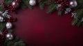 The festive holiday decorations include red and silver ornaments surrounded by frosted pine branches on a deep red Royalty Free Stock Photo