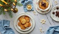 Festive holiday table with cookies, chocolate and candles on marble surface Royalty Free Stock Photo