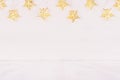 Festive home decor - gold stars lights on soft white wood board.