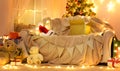 Festive Home interior - wew year or christmas decoration. At night, the room glows with festive lights. A lots of gifts and Royalty Free Stock Photo