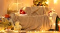 Festive Home interior - wew year or christmas decoration. At night, the room glows with festive lights. A lots of gifts and Royalty Free Stock Photo