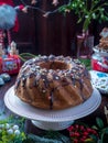 Festive homemade round biscuit cake with hole on porcelain shelf