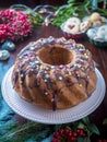 Festive homemade round biscuit cake with hole on porcelain shelf