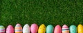 Festive Easter Banner - Colorful Hand Painted Eggs In Row On Fresh Green Grass. Pink, Yellow, Blue. Long Horizontal