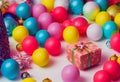 Festive image of a box with a gift. Festive tinsel and balloons.