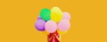 Festive image of unknown woman covering her head and holding in hands bunch of colorful balloons on orange background Royalty Free Stock Photo