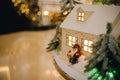 Festive installation in hotel. Houses with small Christmas tree and festive lights