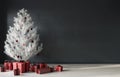 Festive interior in gray with a white Christmas tree and red decorations Royalty Free Stock Photo