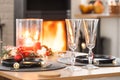 Festive interior of house is decorated for Christmas and New Year in loft style with black stove, fireplace, Christmas tree. Warm Royalty Free Stock Photo