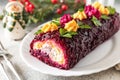 Festive layered shuba salad. Traditional Russian Christmas New Year vegetable salad roll with herring and boiled vegetables