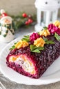 Festive layered shuba salad. Traditional Russian Christmas New Year vegetable salad roll with herring and boiled vegetables. Copy