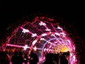 Festive light tonnel with silhouettes of people Royalty Free Stock Photo