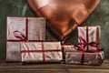 Festive lilac gift boxes on wooden table. Concept of birthday, joy of event. Red ribbons wrap Royalty Free Stock Photo