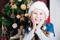 Festive little girl smiling camera against home with christmas tree Royalty Free Stock Photo