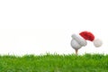 Festive-looking golf ball on tee with Santa Claus` hat Royalty Free Stock Photo