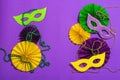 Festive Mardi Gras masquerade purple background. Fat Tuesday carnival, masks, beads, traditional decor Royalty Free Stock Photo