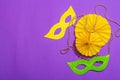 Festive Mardi Gras masquerade purple background. Fat Tuesday carnival, masks, beads, traditional decor Royalty Free Stock Photo